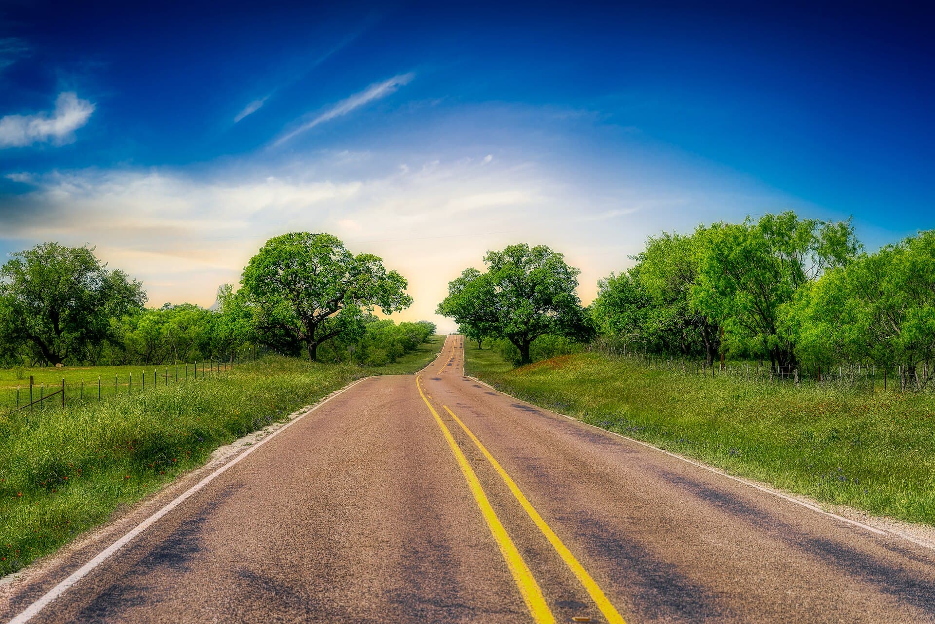 A quiet road winding through the Texas Hill Country